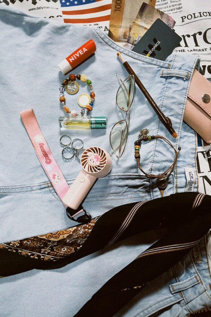 A flat-lay of everyday fashion accessories arranged on denim