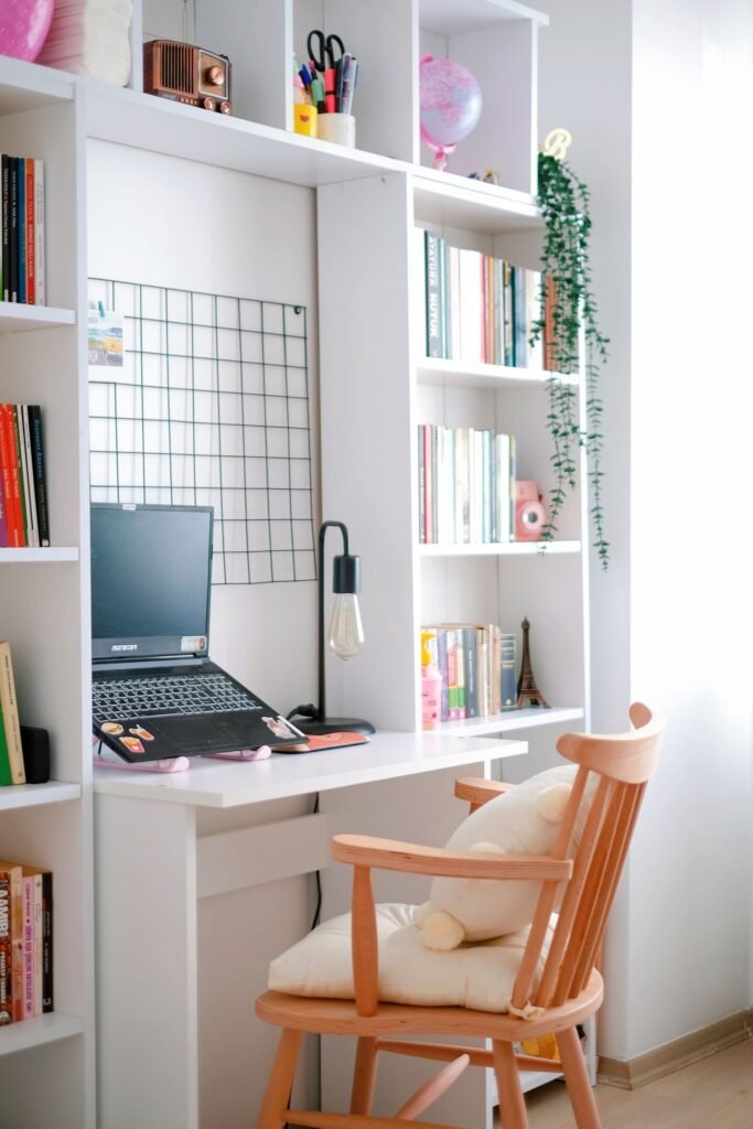 Cozy student desk setup for back-to-school tech accessories, including a laptop and organized shelving