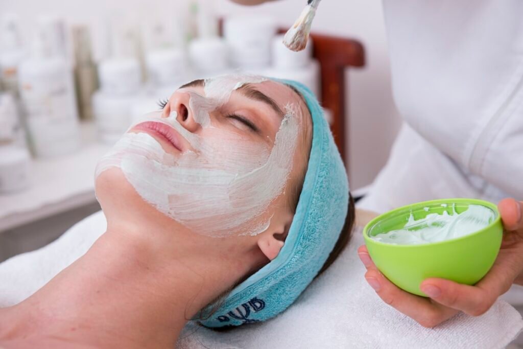 Woman using gua sha stone for facial massage β skincare tools Canada