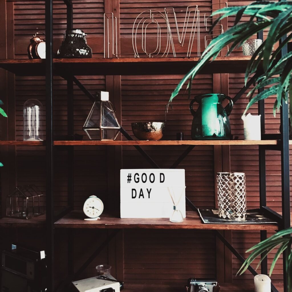 Decorative home shelf styled with personalized items, plants, and small keepsakes